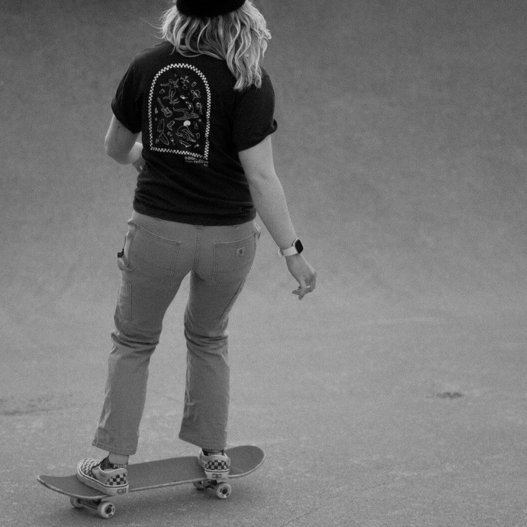 Blonde skater model wearing Goofy Apparel Dark Brown T with back graphic